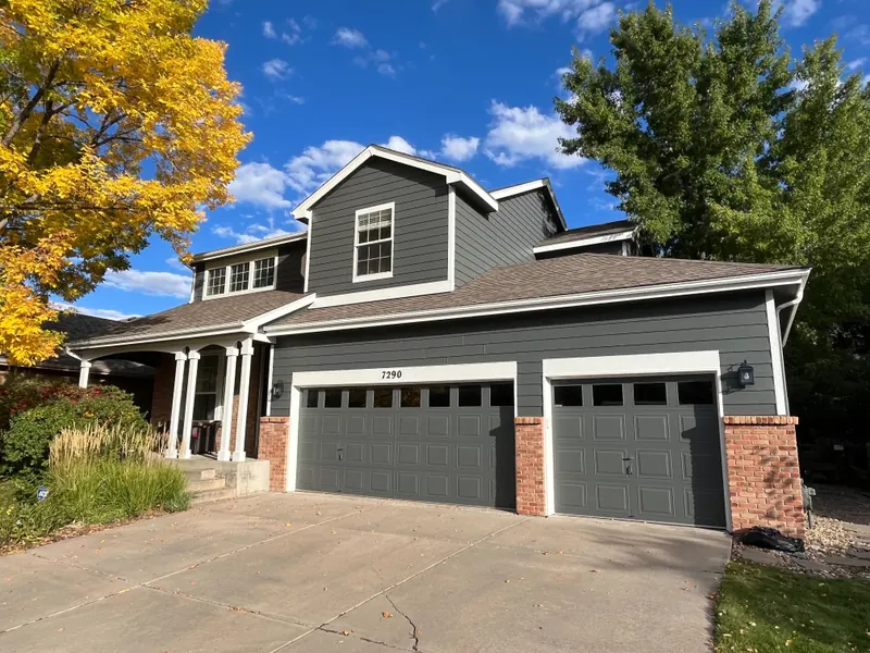 Repainted charcoal gray two-story home with brick accents in Arvada